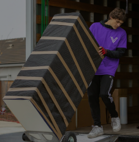 Mover loading a large wrapped item for a commercial move