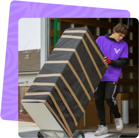 Mover loading a wrapped item onto the moving truck