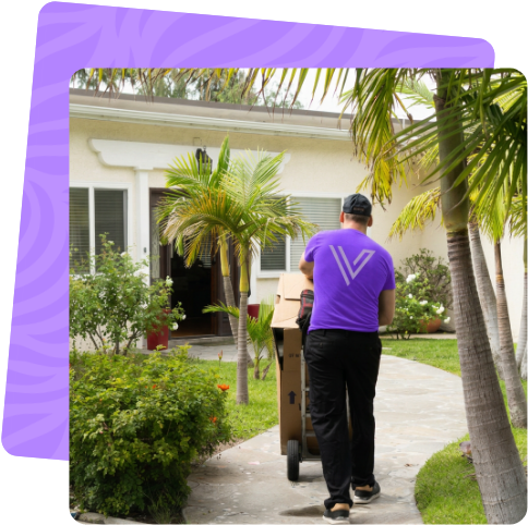 Mover wheeling boxes up the path to a home